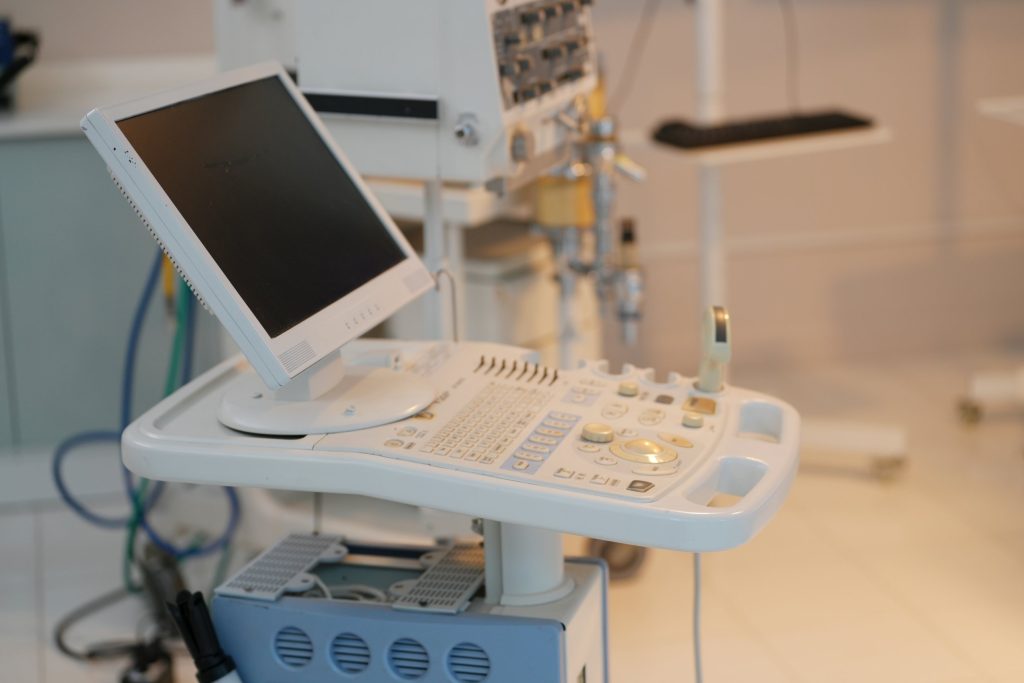 Ultrasound scanner with monitor and control panel in a hospital room