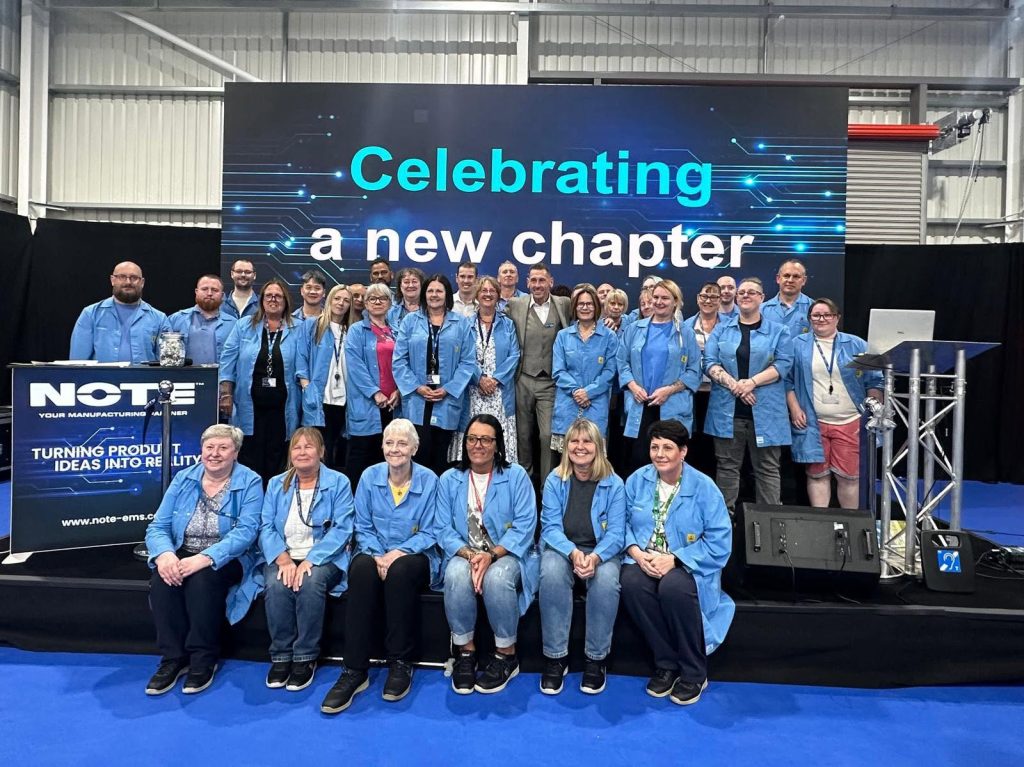 NOTE in the UK colleagues in blue lab coats gathered on stage at a celebration event